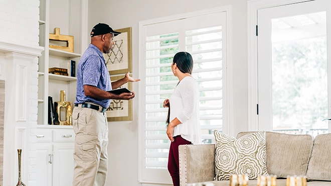 Window Genie service professional explaining options to a customer inside her home.