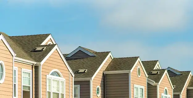 The roofs of multiple townhouses or apartments in a row.