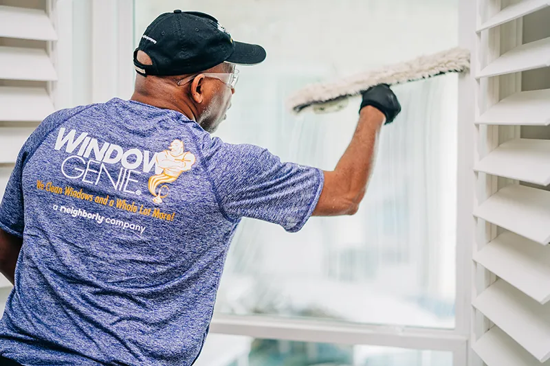 Window Genie tech performing window cleaning services.