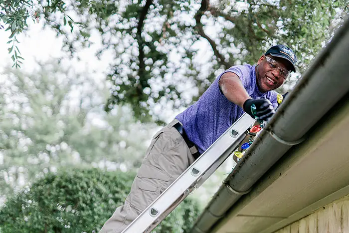 Window Genie tech doing a professional Christmas light installation at a home in Roseville, CA