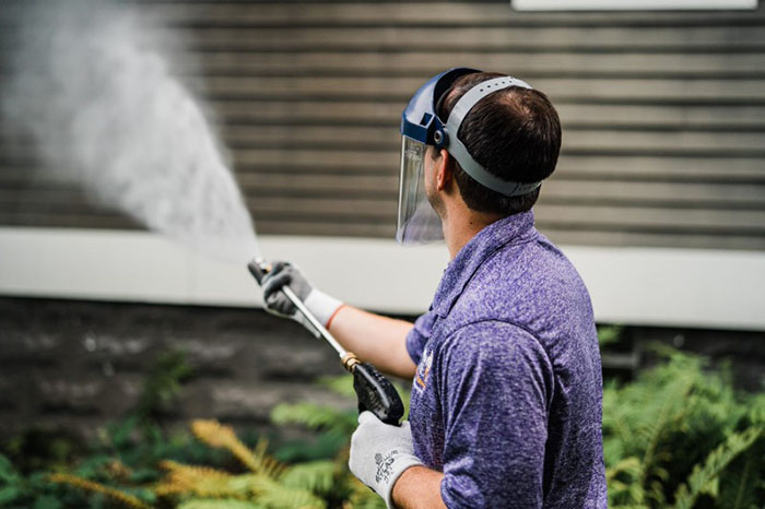 Window Genie tech performing house washing in Oshkosh, WI