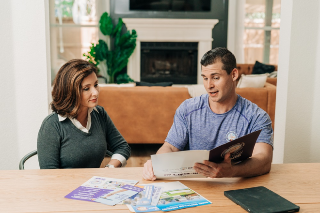 Window Genie technician consulting with a customer.