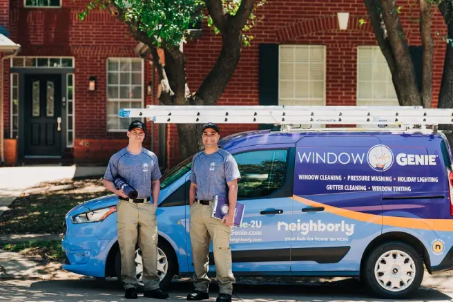 Window Genie service professionals standing outside of a house.