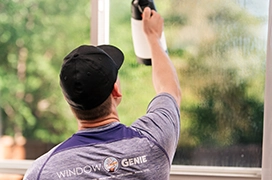 Man removing window film.