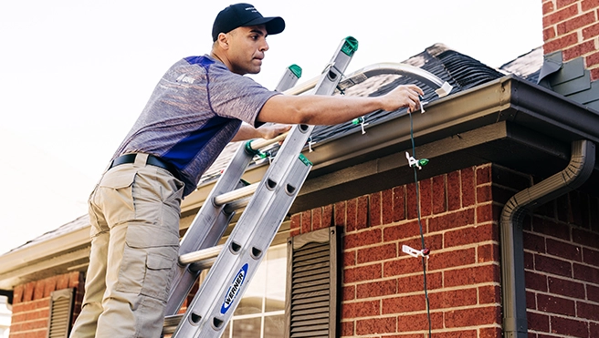 Window Genie customer greeting a technician at the door with a smile on her face.