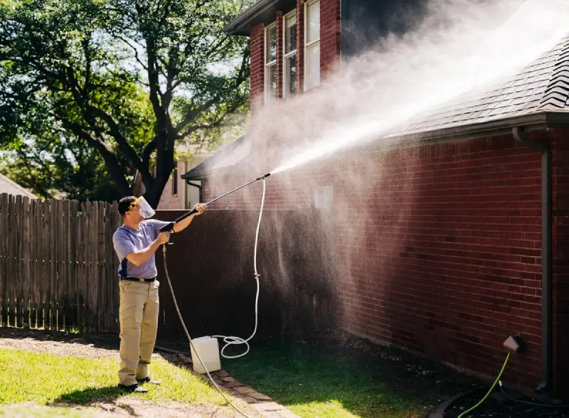 Window Genie professional pressure washing a roof.